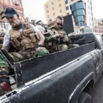 Miliciens irakiens présents en Iran illustrant les enjeux sécuritaires et politiques transfrontaliers au Moyen‑Orient.