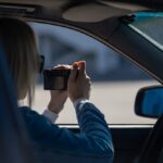 Silhouette d’un détective privé observant une rue sombre, carnet en main, éclairé par un lampadaire, symbolisant les enquêtes, les filatures et la recherche de vérité.