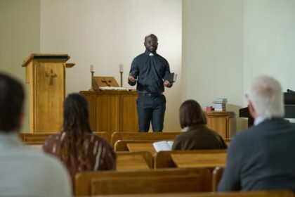 Salle de culte évangélique bondée en banlieue, fidèles en prière, ambiance musicale intense, symbolisant la concurrence religieuse dans les quartiers populaires.