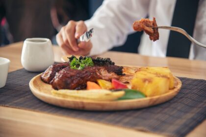 Un éleveur français guidant son troupeau dans une prairie, illustrant la qualité, le savoir-faire et l’engagement de la filière bovine nationale.