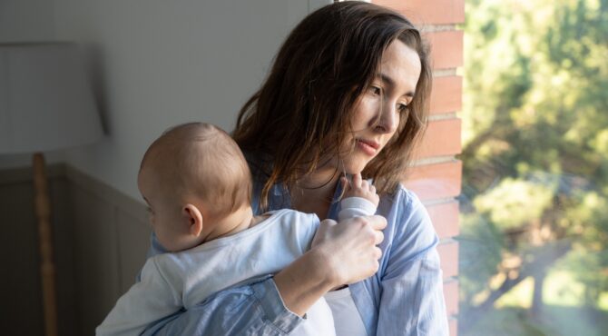 Portrait d’une mère seule avec son enfant dans un environnement urbain, illustrant la précarité croissante des familles monoparentales en France.